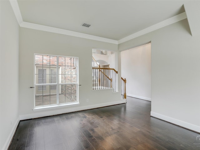 spare room featuring stairs, visible vents, wood finished floors, and ornamental molding