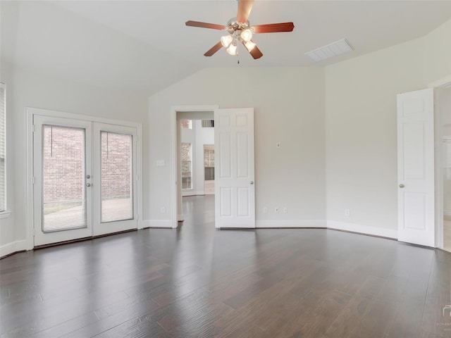 unfurnished room featuring french doors, visible vents, vaulted ceiling, wood finished floors, and baseboards