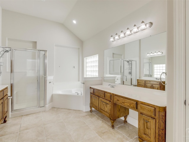 full bath with a stall shower, tile patterned flooring, vaulted ceiling, vanity, and a bath