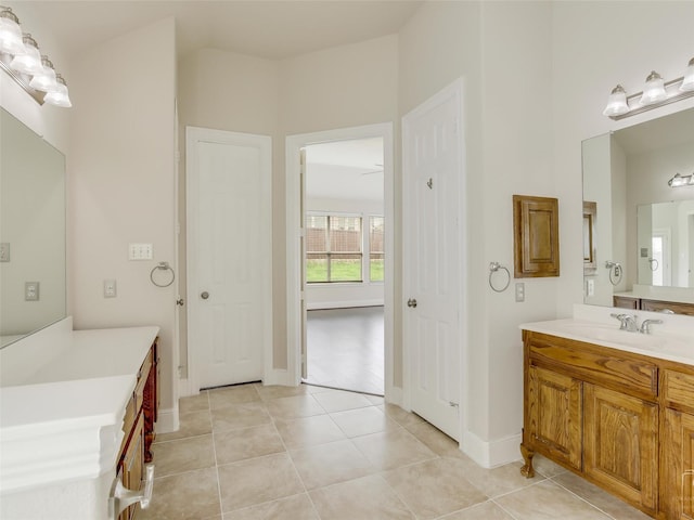 bathroom with baseboards, vanity, and tile patterned floors