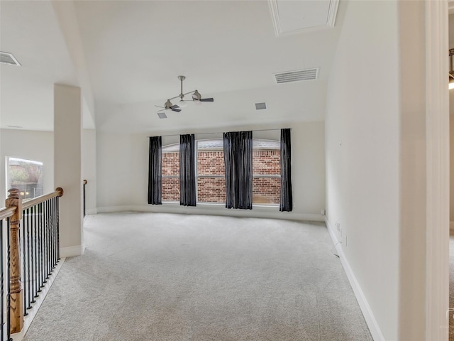 empty room with baseboards, visible vents, and light colored carpet