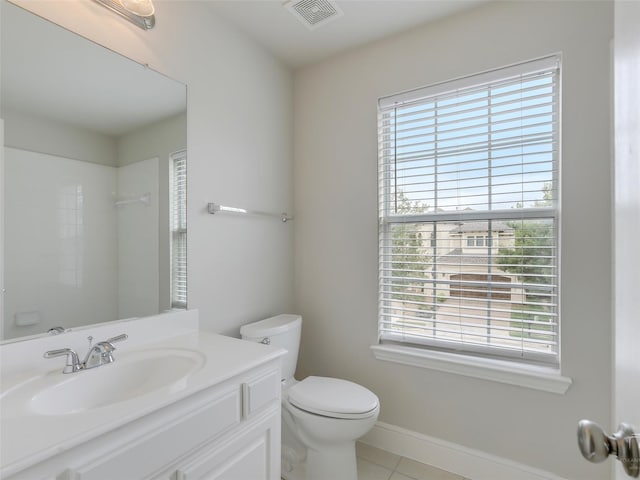 bathroom featuring toilet, plenty of natural light, vanity, and visible vents