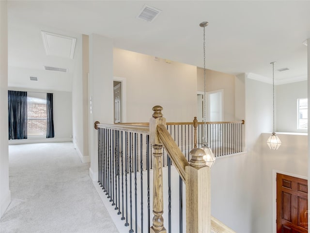 hall featuring carpet, an upstairs landing, and visible vents