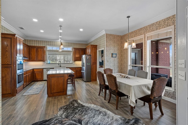dining area featuring visible vents, crown molding, wallpapered walls, recessed lighting, and light wood finished floors