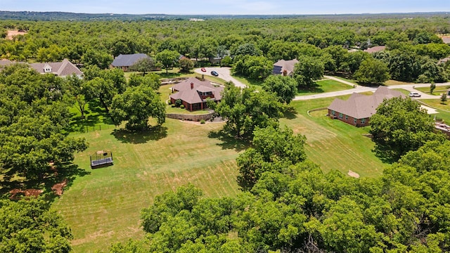 drone / aerial view featuring a view of trees