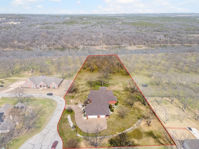 birds eye view of property with a wooded view