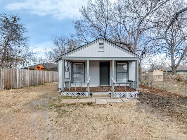 bungalow-style house with covered porch and fence