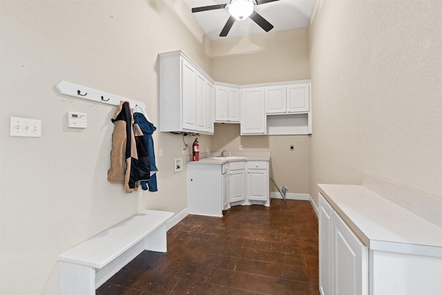 mudroom with a ceiling fan, dark wood-style flooring, a sink, and baseboards