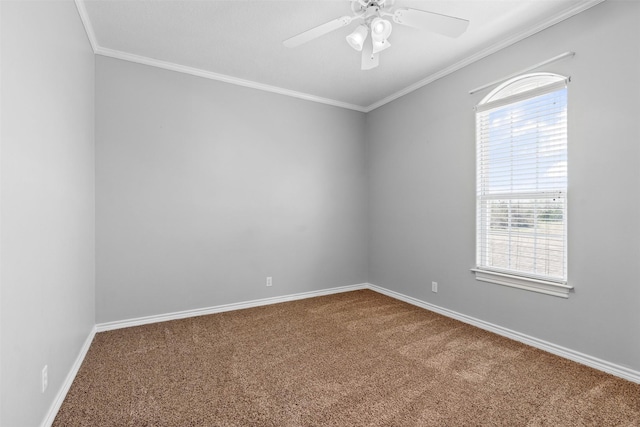 spare room with baseboards, carpet floors, a ceiling fan, and crown molding