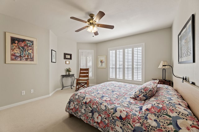 carpeted bedroom with baseboards and a ceiling fan