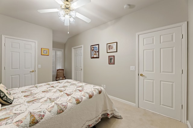 bedroom with light carpet, ceiling fan, lofted ceiling, and baseboards