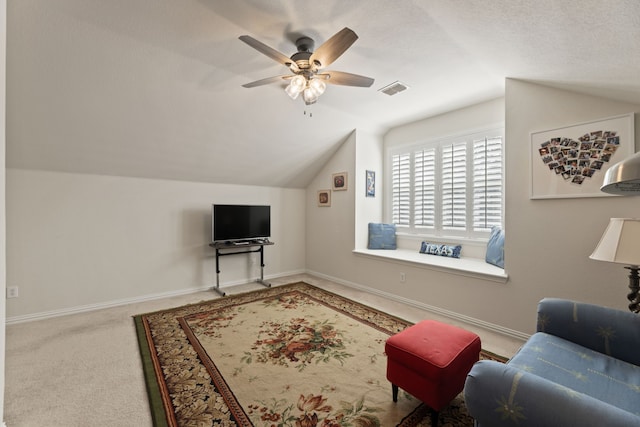 carpeted living room with lofted ceiling, visible vents, a ceiling fan, a textured ceiling, and baseboards