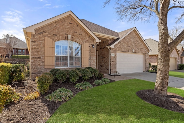 view of front facade with brick siding, roof with shingles, a front yard, a garage, and driveway