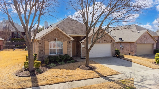 view of front of home featuring a front lawn, brick siding, fence, and an attached garage