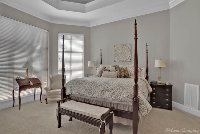 bedroom featuring carpet floors, a tray ceiling, visible vents, and crown molding