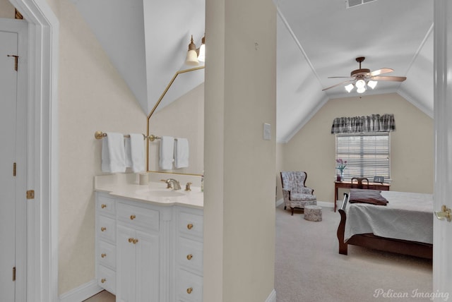 bathroom featuring ceiling fan, connected bathroom, vanity, baseboards, and vaulted ceiling