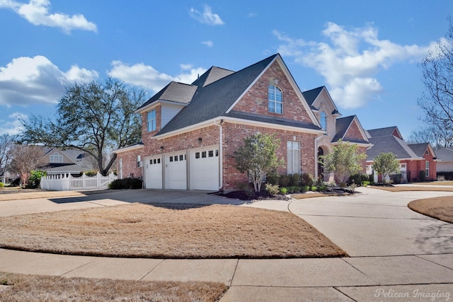 traditional-style home featuring an attached garage, brick siding, a shingled roof, fence, and driveway