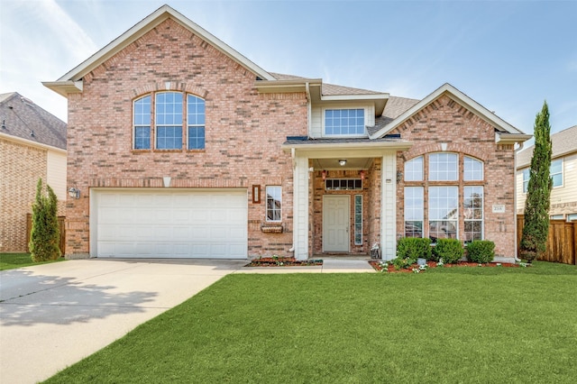 traditional-style home featuring brick siding, a front yard, fence, a garage, and driveway