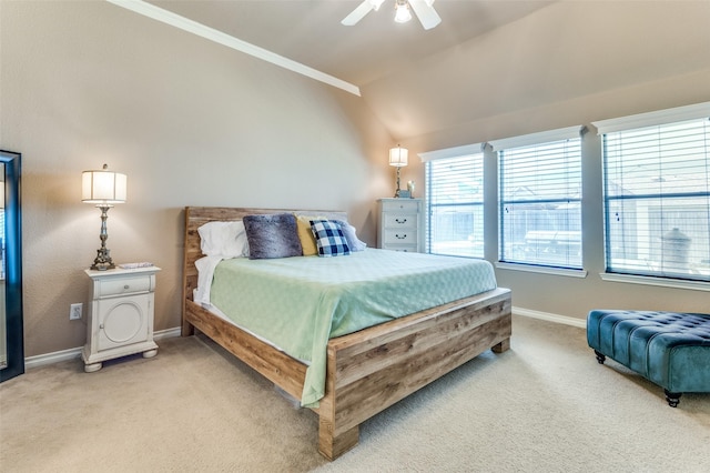 bedroom featuring ornamental molding, light carpet, baseboards, and a ceiling fan