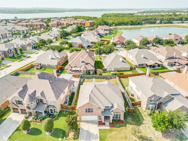 birds eye view of property with a water view and a residential view