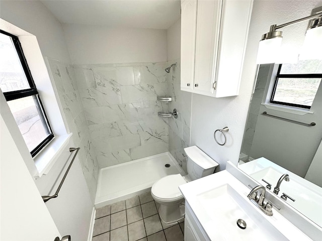 bathroom with toilet, a stall shower, tile patterned flooring, and vanity