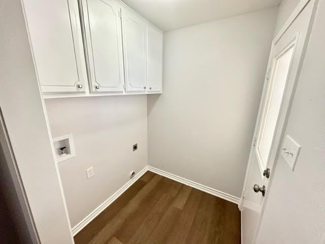 laundry room featuring dark wood-type flooring, washer hookup, baseboards, cabinet space, and electric dryer hookup