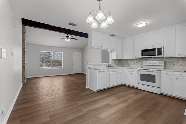 kitchen featuring visible vents, backsplash, white appliances, and a sink