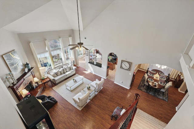 living area featuring visible vents, a brick fireplace, ceiling fan, wood finished floors, and high vaulted ceiling