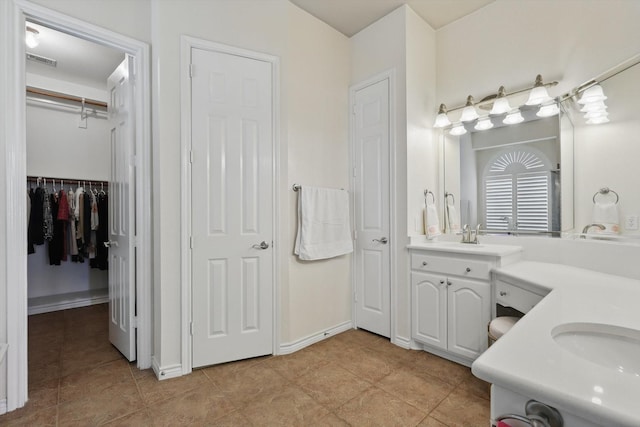 bathroom with tile patterned floors, baseboards, visible vents, and vanity