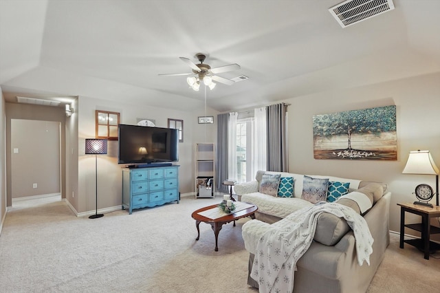 living area with vaulted ceiling, ceiling fan, visible vents, and light colored carpet