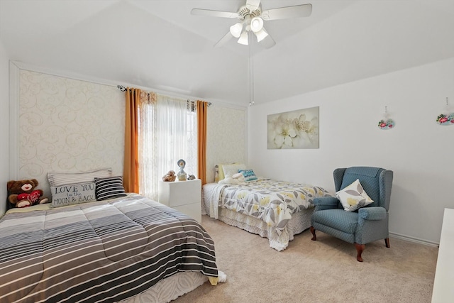 bedroom with vaulted ceiling, carpet, and a ceiling fan