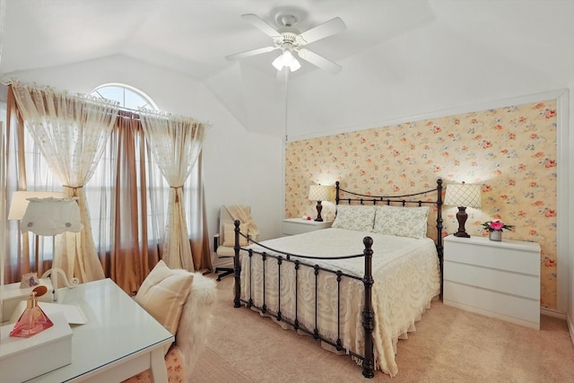 bedroom with lofted ceiling, light carpet, ceiling fan, and wallpapered walls