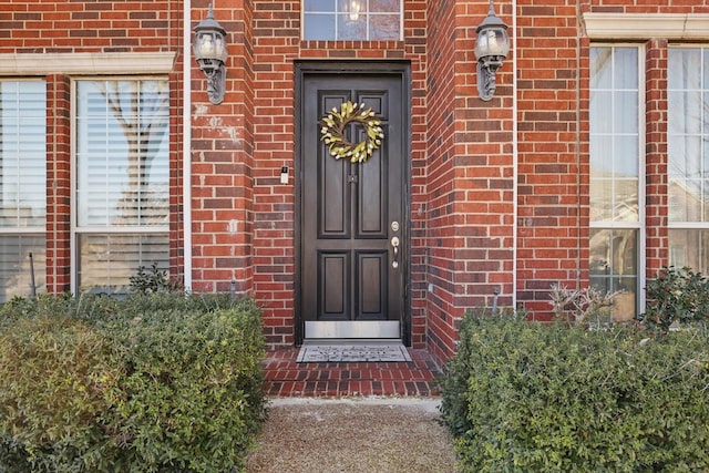 doorway to property with brick siding