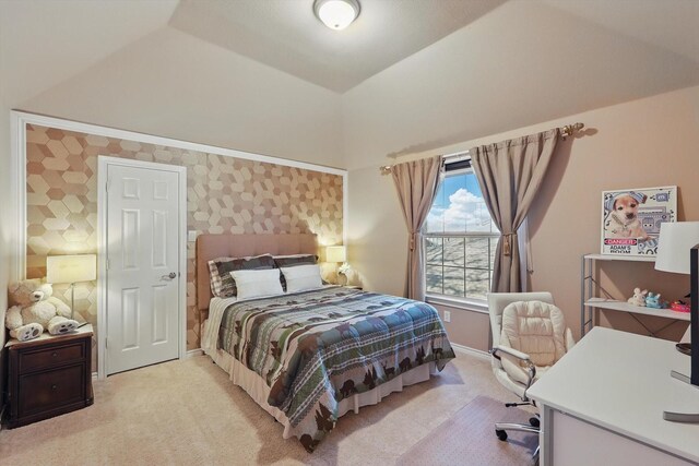 bedroom featuring baseboards, lofted ceiling, and light colored carpet