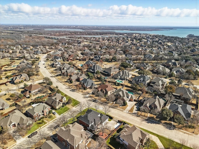 drone / aerial view with a water view and a residential view