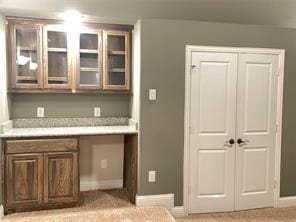 bar with built in desk and baseboards