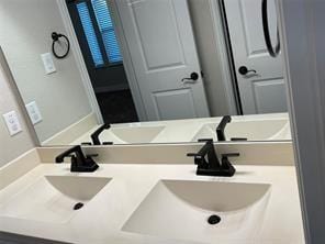 bathroom with a sink and double vanity