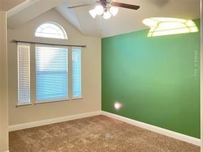 empty room with carpet floors, ceiling fan, baseboards, and lofted ceiling