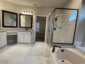 bathroom featuring a jetted tub, a stall shower, and vanity