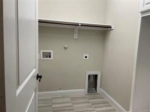 clothes washing area with hookup for a gas dryer, hookup for an electric dryer, laundry area, washer hookup, and baseboards