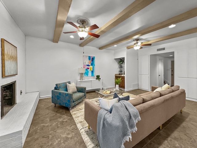 living area with a fireplace with raised hearth, recessed lighting, visible vents, baseboards, and beam ceiling