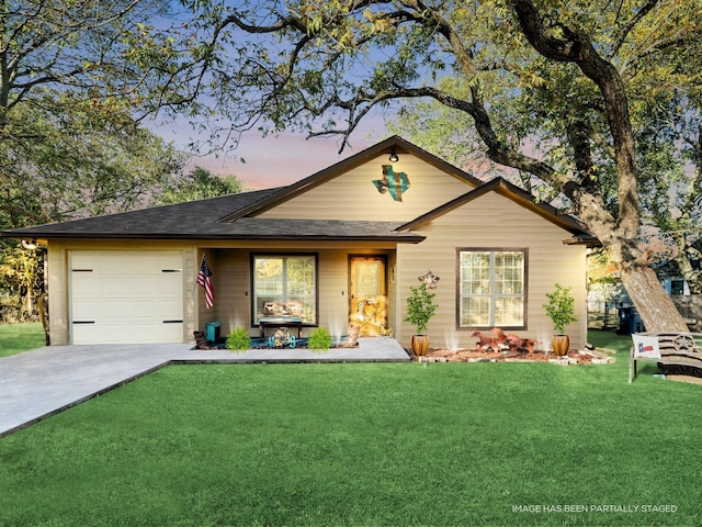 view of front of home with a porch, a yard, roof with shingles, concrete driveway, and a garage