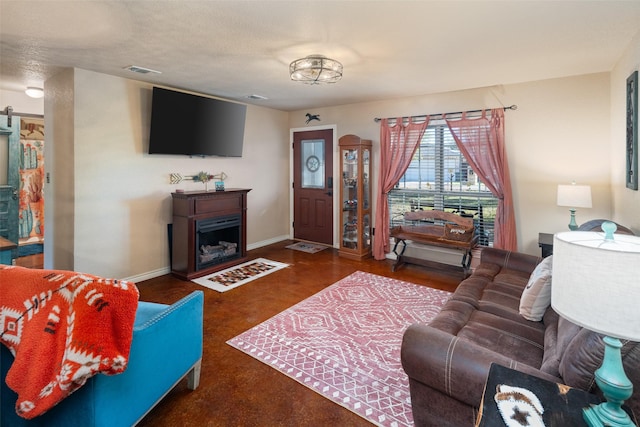 living area with a fireplace, visible vents, and baseboards