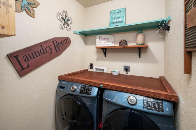 washroom featuring laundry area and washing machine and dryer