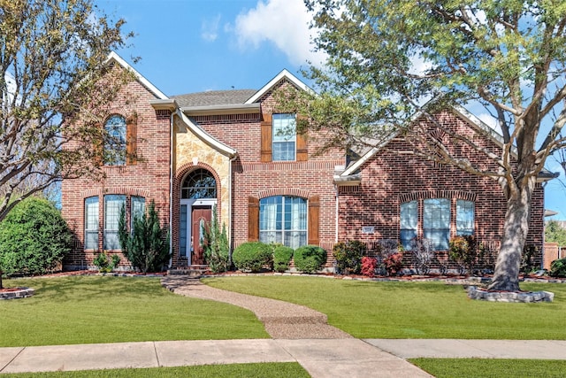 traditional-style house featuring brick siding and a front lawn