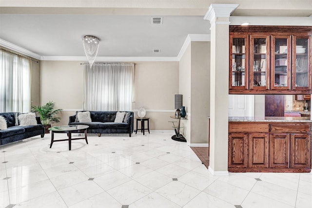 living room with crown molding, visible vents, and ornate columns