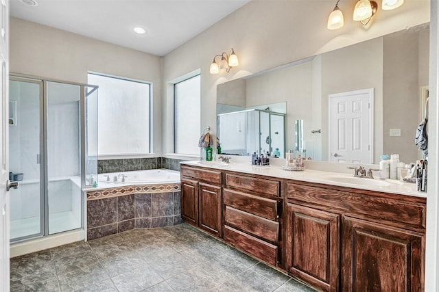 bathroom with double vanity, a sink, a shower stall, and a bath