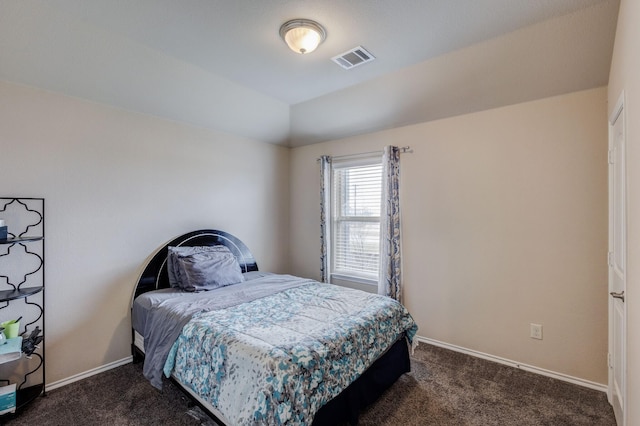 bedroom featuring visible vents, baseboards, dark carpet, and vaulted ceiling