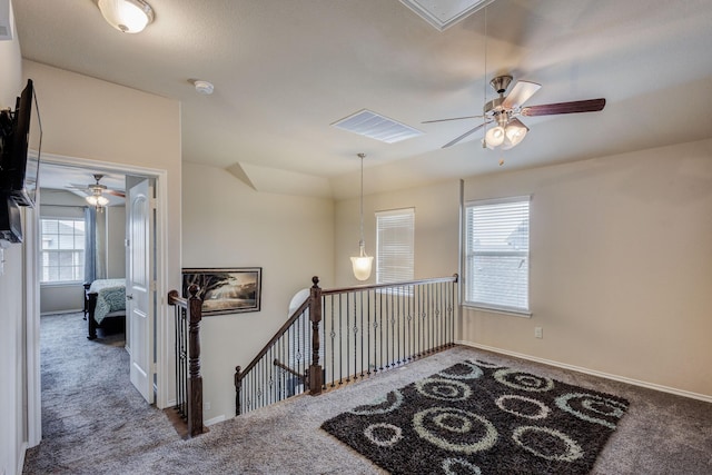 staircase with attic access, carpet flooring, baseboards, and visible vents