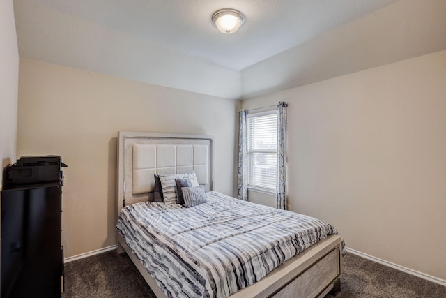 bedroom featuring dark carpet and baseboards